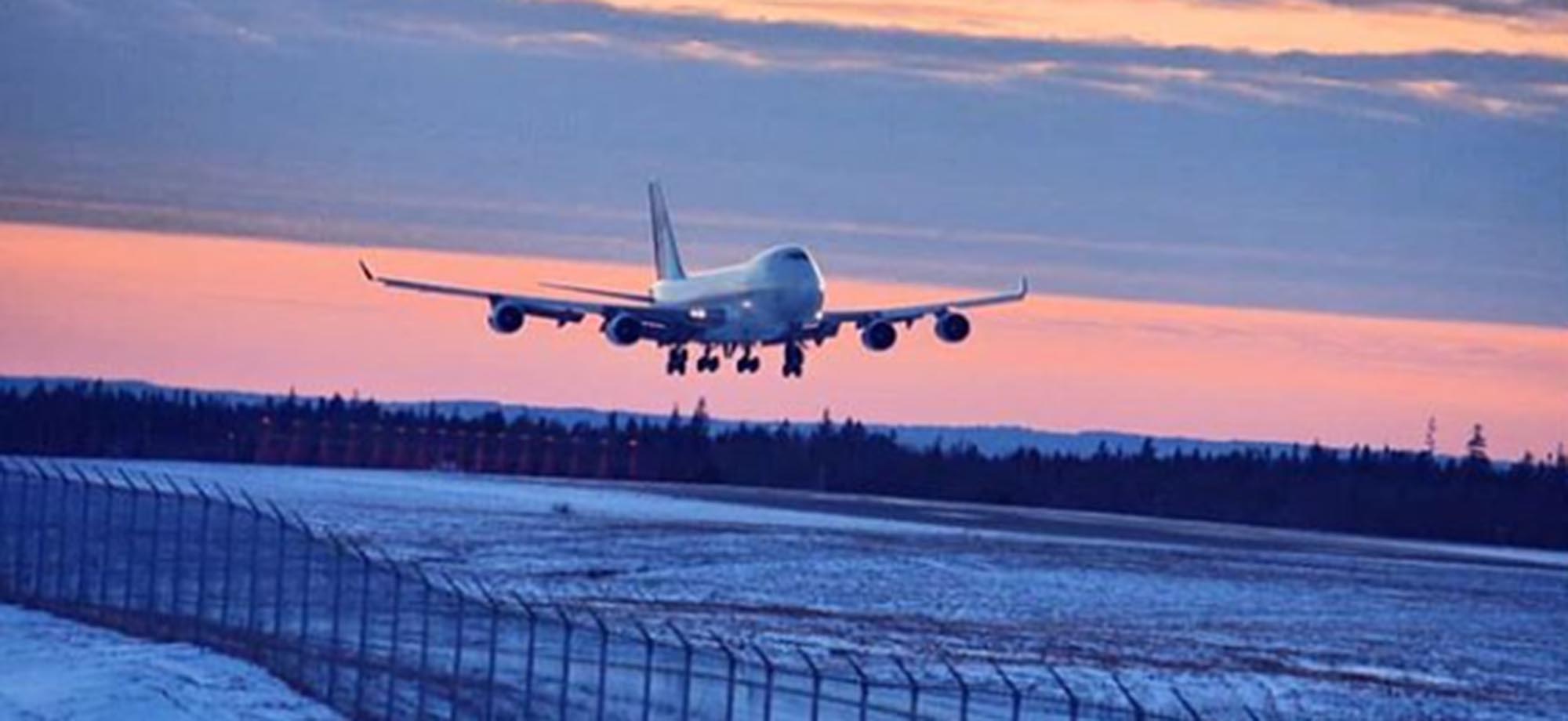 An airplane taking off at sunset
